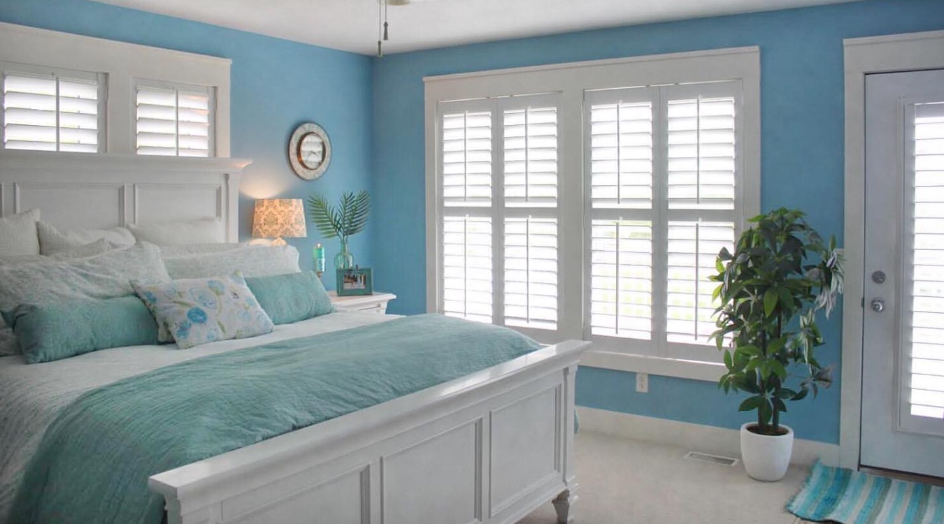 Bedroom with white shutters