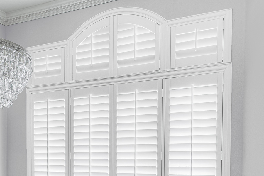 Customize your Palladian windows with white Polywood shutters in Destin. White Polywood Palladian windows in a dining room.