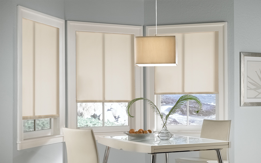 Roller shades in modern white kitchen.