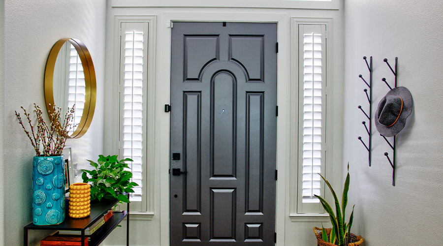 Sidelight window shutters next to front door.