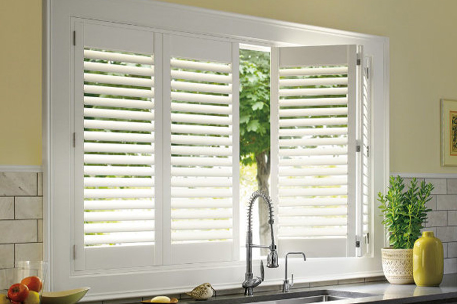 Polywood shutters are built to withstand the test of time in Destin. White Polywood shutters above a kitchen sink.