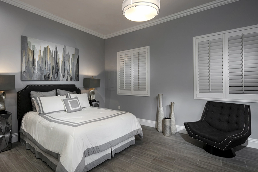 Close your custom Polywood shutters to beat the heat and keep your Destin bedroom cool. White Polywood shutters on bedroom windows