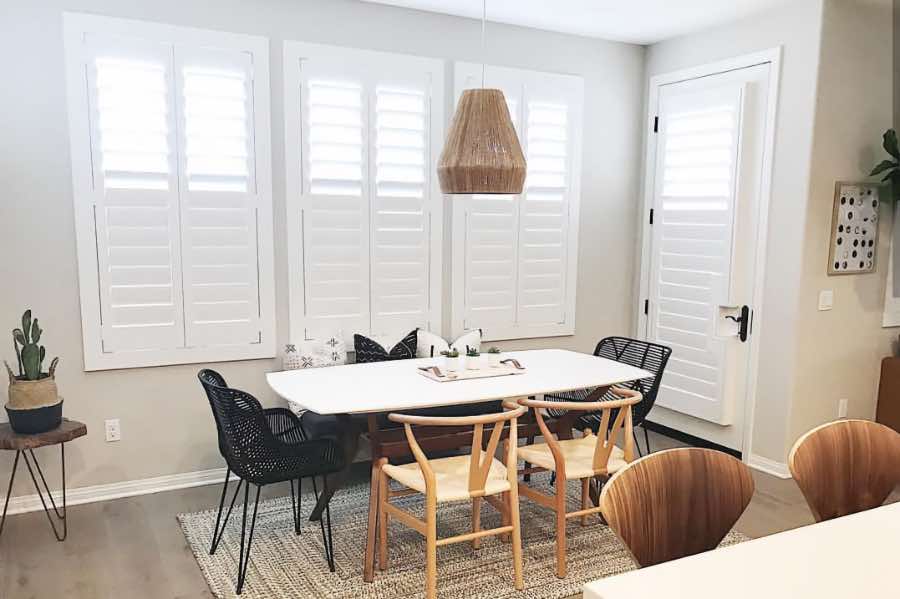Use Polywood shutters to control natural light levels in your Destin dining room. Polywood shutters with top louvers tilted open in a dining room