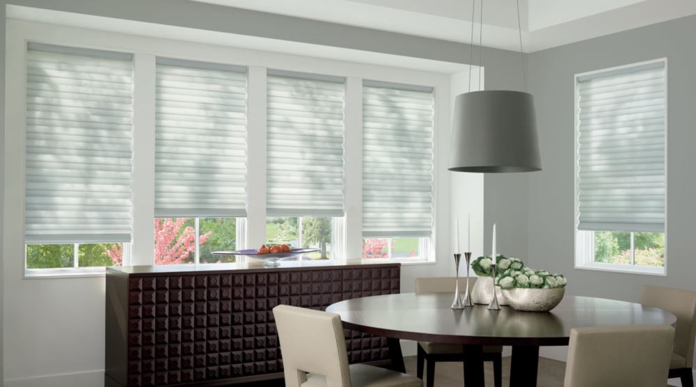 Custom cordless roller shades have a clean look and are appropriate for any room. Cordless motorized shades in a Destin dining room