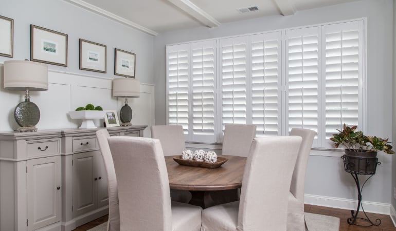 Plantation shutters are a perfect choice for homeowners looking for privacy or natural light. Plantation shutters in a Destin dining room.