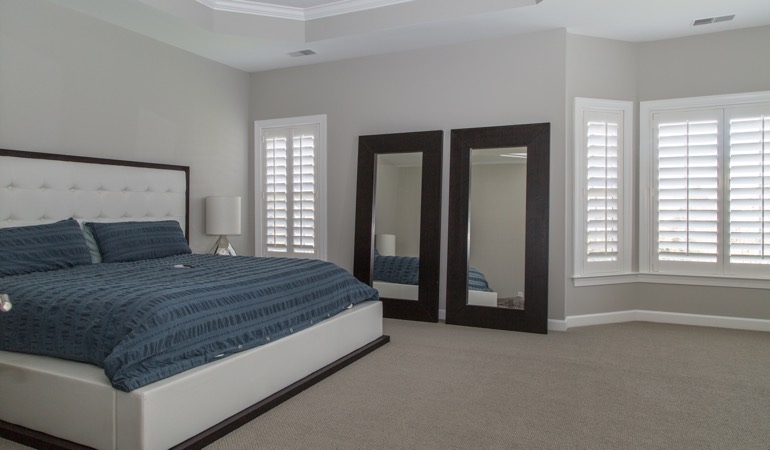 Polywood plantation shutters combine form and function. Polywood shutters in a minimalist bedroom in Destin.