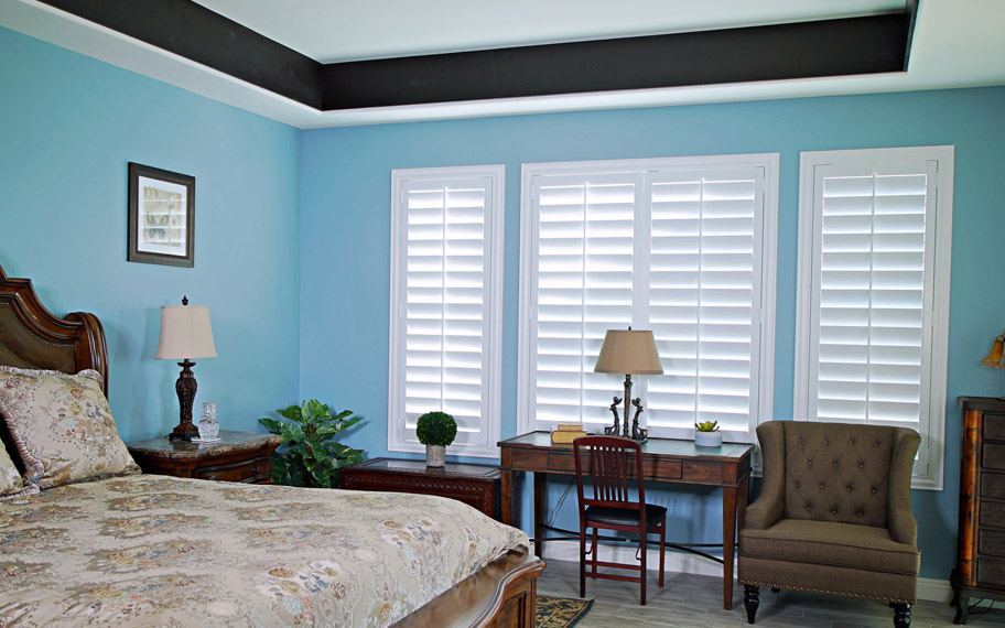 Polywood shutters provide insulation for the perfect temperature all year long in Destin. Polywood shutters in a bedroom.