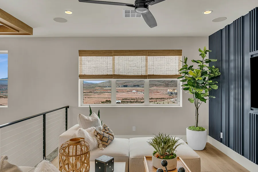 Destin homeowners who want eco-friendly home fixtures should consider natural woven shades. Natural brown woven shades on a window in a stylish sitting area
