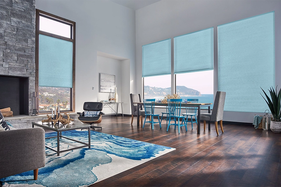 Smart motorized window shades are perfect on tall windows in your Destin home. Blue motorized shades on tall living room windows