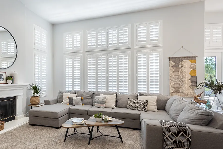 Versatile Polywood shutters look and work great on all kinds of windows. White Polywood shutters on tall living room windows