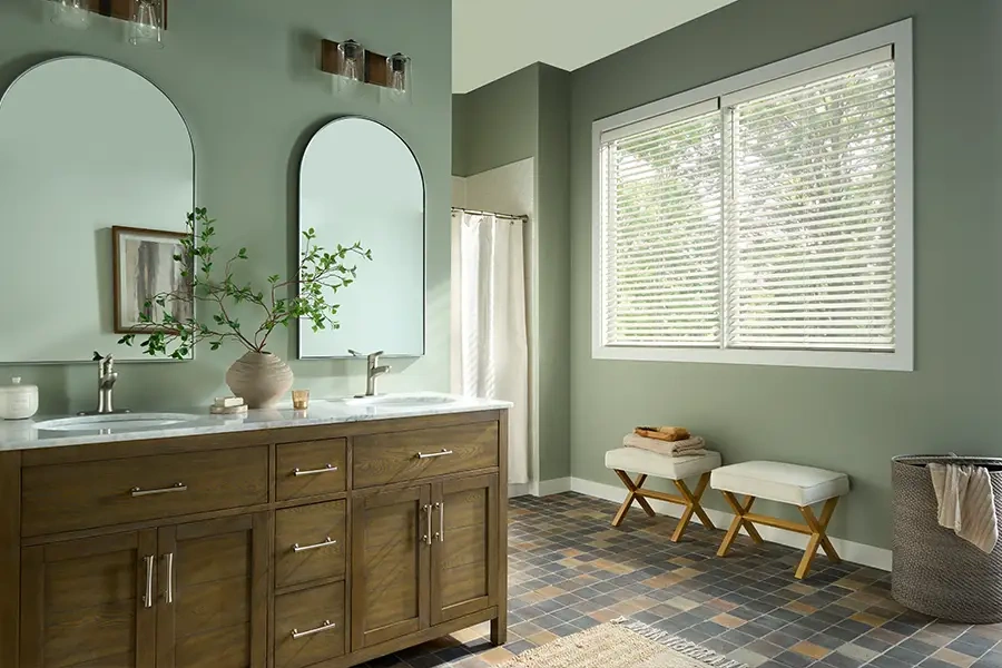Blinds fit within windows, so they're perfect in small rooms with little floor space beneath the window. white wooden blinds in a smal bathroom area